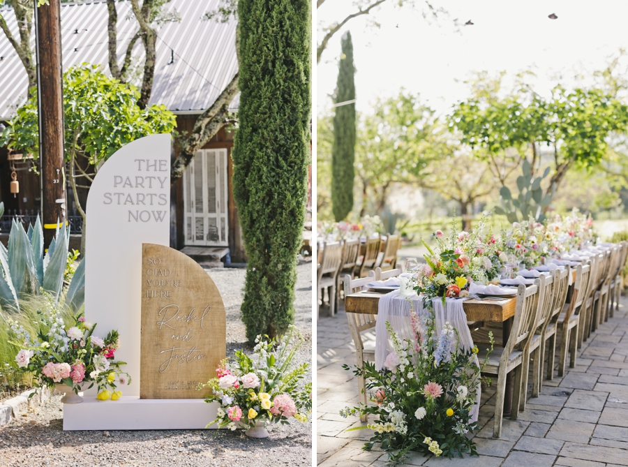 A curved modern design sign and flowers next to a long banquet table with table settings