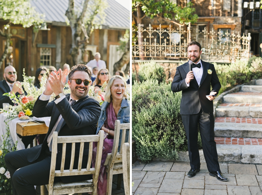 Guests laugh as a man gives a toast in a tux