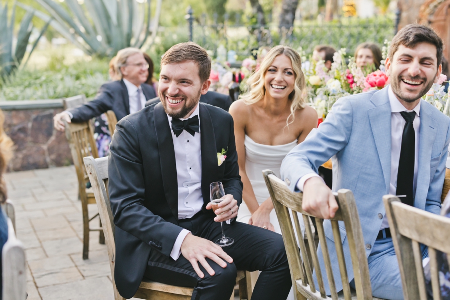 a groom laughs in a tux with a bride laughing in her wedding dress at SSS Ranch in Napa