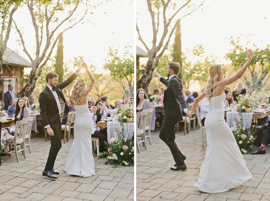 A groom lifts a bride's hand to twirl her on an outdoor dance floor at Triple S Ranch