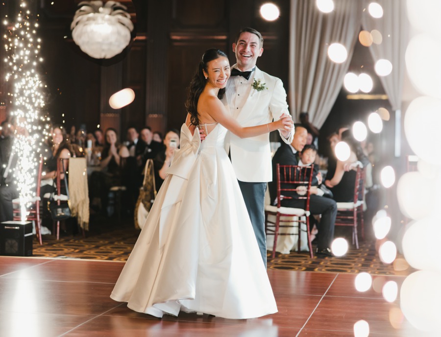 A bride and groom smile while dancing at their Julia Morgan Ballroom wedding reception.